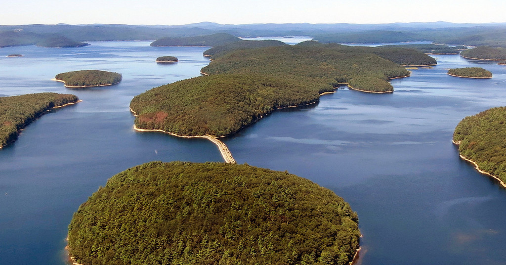 A dirt and stone road leads to Mount Zion Island, at rear, at the Quabbin Reservoir in Petersham, Mass. A plan by the state to start a colony of venomous timber rattlesnakes on the off-limits island in the state's largest drinking water supply came under fire, and became one of New England's odd stories in 2016. 