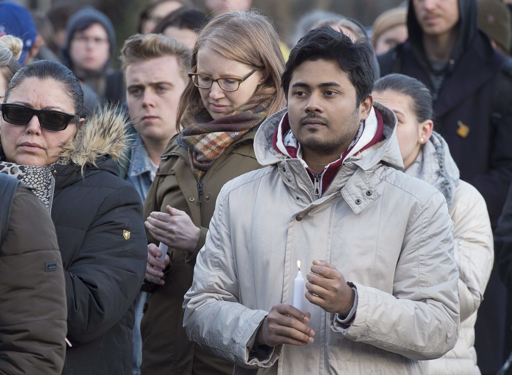 People attend a vigil for victims of a Sunday shooting at a mosque in Quebec City, at Dalhousie University in Halifax on Monday. Multiple people died in the attack which occurred during evening prayers.