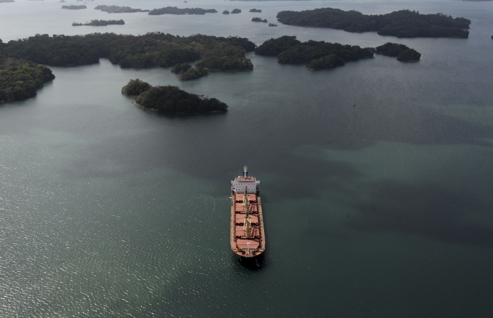 A container ship waits to enter the locks in Gatun, Panama, on March 23. Many mariners say adventure and the ocean are more important than job security and good pay.