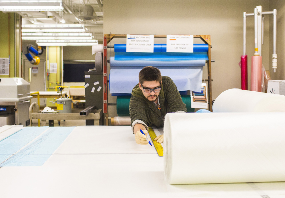 Maine Composites Alliance technician Drew Sfirri cuts a piece of mesh polypropylene at Southern Maine Community College in Brunswick in December. When the alliance and SMCC couldn’t come to terms, the equipment was moved into new space at the nearby TechPlace building.