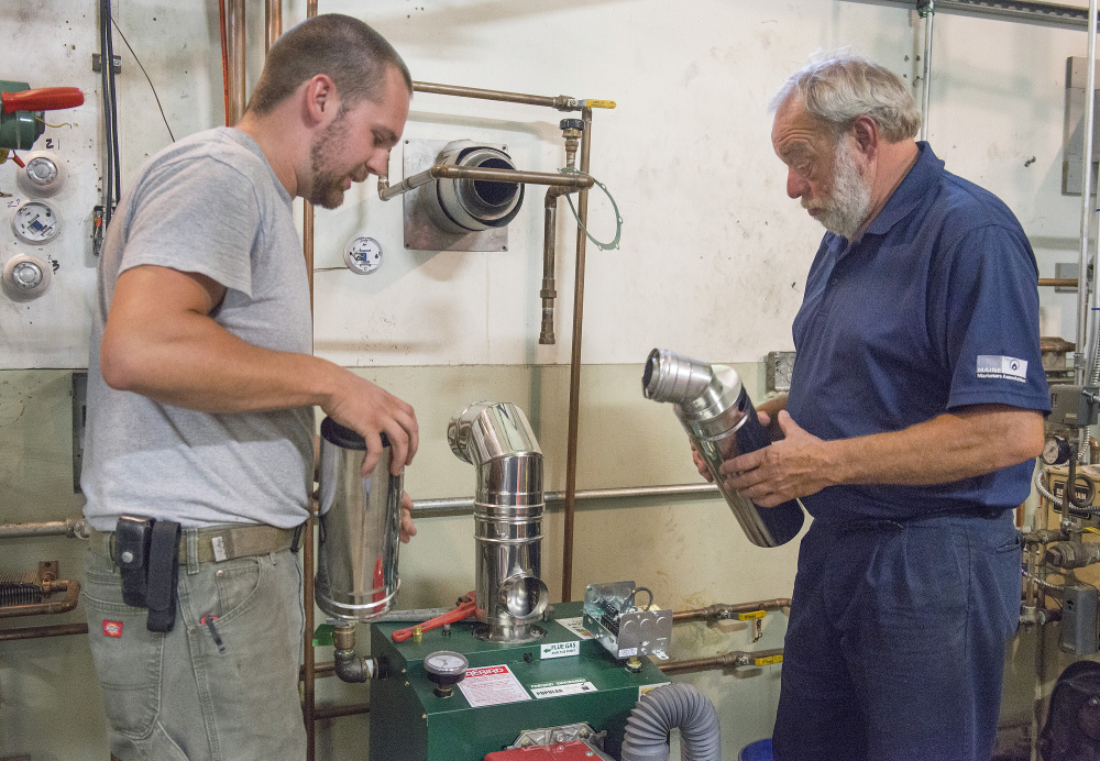 Trevor Rollins, 28, left, discusses options for venting a furnace with senior instructor Bryan Champagne. Rollins already works in HVAC and enrolled at the technical center to take specific courses to expand his areas of expertise.