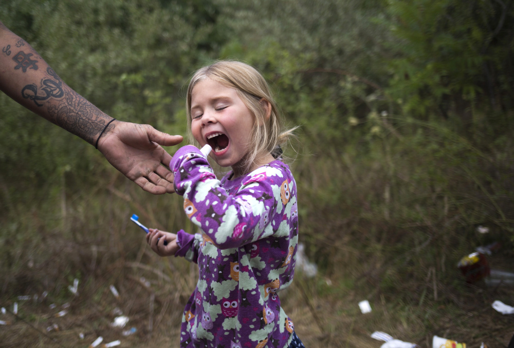 Troy reaches for the toothpaste to prevent Arianna from trying to open it with her teeth. Arianna thinks of Troy as a father and he sees her as his daughter. Troy often reminds Arianna, "Even though you are living in the woods that doesn't mean you have to act like it."