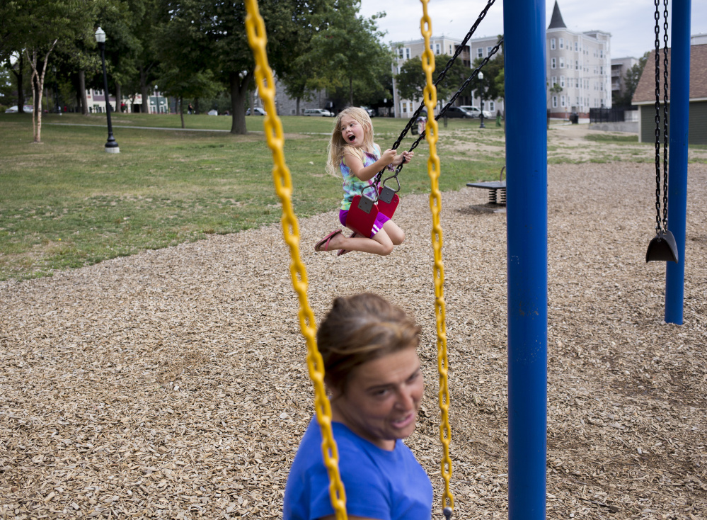 Arianna plays for hours at Kennedy Park in Lewiston while her mother and Troy wait to hear if they will be able to move into the apartment in Auburn.