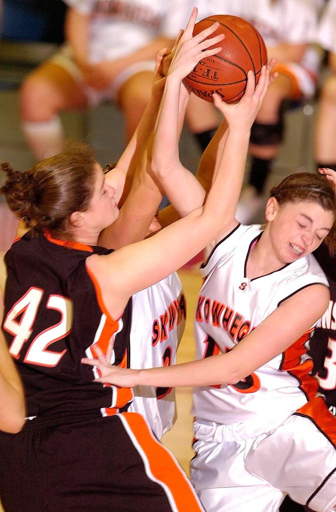 Staff photo by Joe Phelan Brunswick freshman center Lydia Caputi, left, Skowhegan senior forward Jaimi Poland, middle, and junior guard Adrienne Davis during the Eastern Maine Class A regional girls basketball championship Friday at the Augusta Civic Center. Skowhegan won 38-36.