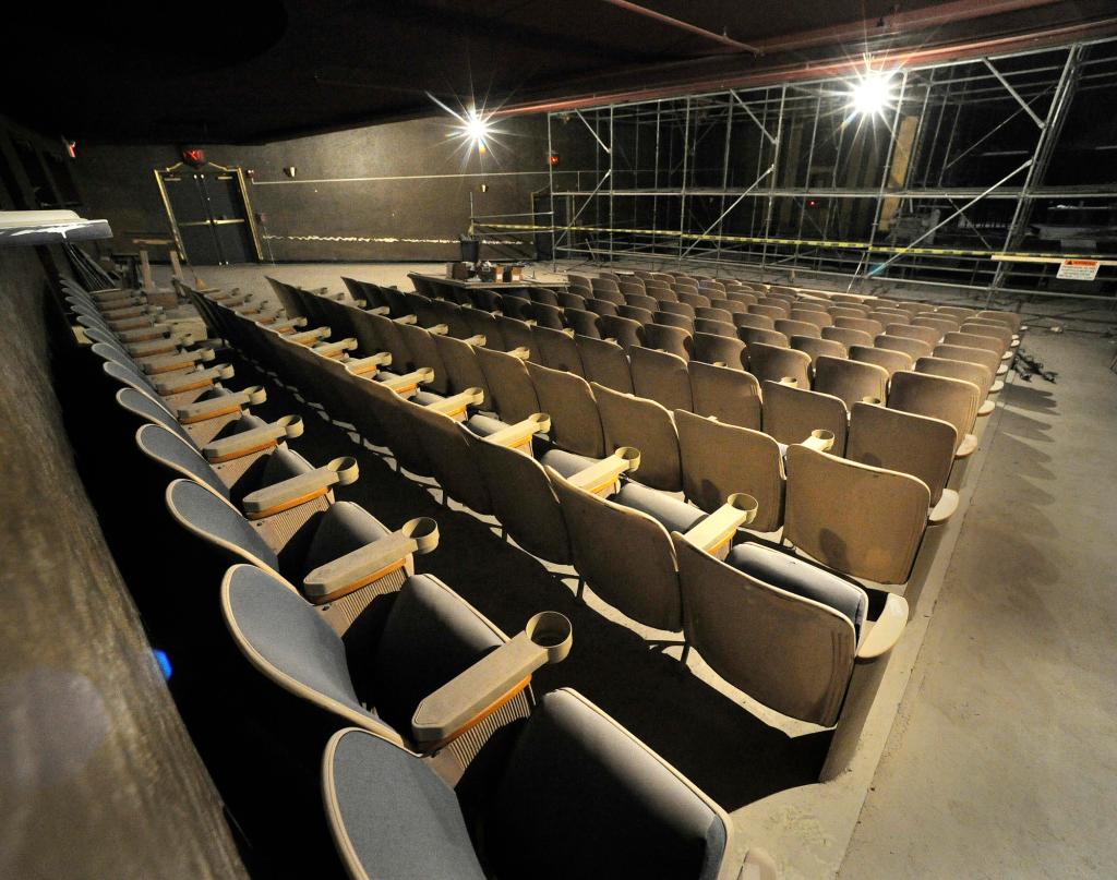 Dust covers seats in the theater as renovation on the building's plaster ceiling is under way.