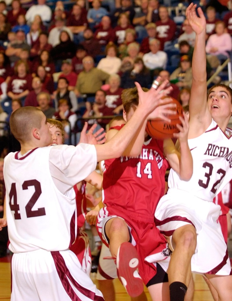 Stephen Osgood of Vinalhaven gets double-teamed by Thomas Carter, left, and Wade Tuttle.