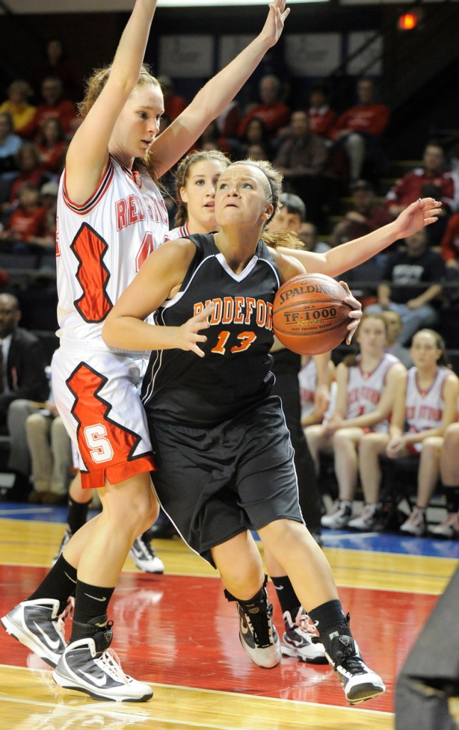 Keila Grigware of Biddeford drives the baseline against Christy Manning.