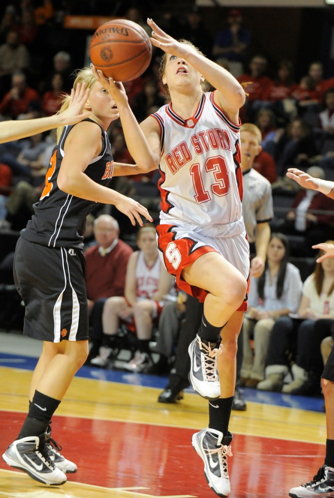 Ellie Morin of Scarborough drives past Biddeford's Amethyst Hersom.