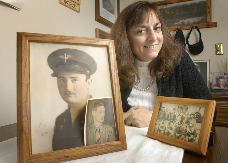 John Ewing/Staff Photographer Lisa Phillips of Windham shows photos of her uncle, 2nd Lt. Joseph C. Rich of Portland. A search group recently located the site in India where his remains are believed to be. Phillips heads a group that lobbies to repatriate the remains of World War II servicemen who vanished overseas.