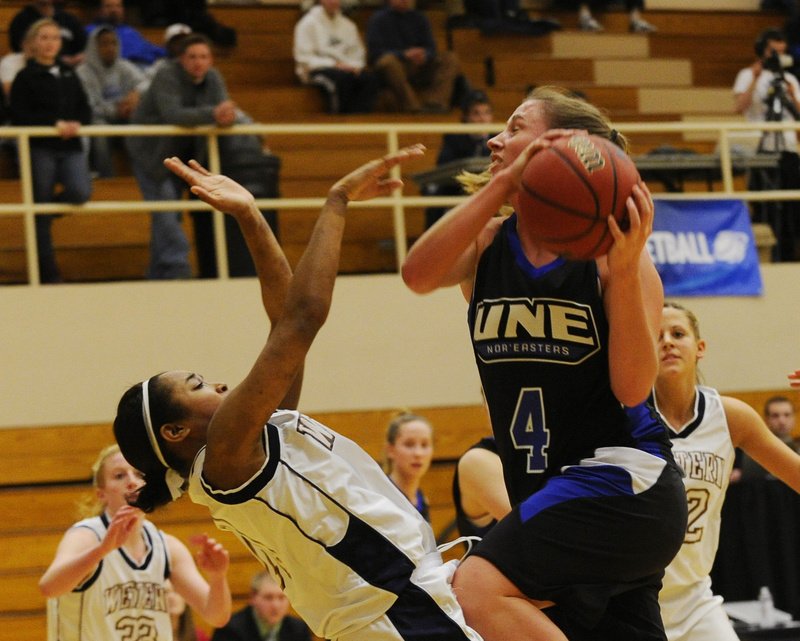 Carrie Bunnell drives to the basket Friday during the University of New England’s 59-41 loss to Western Connecticut State in the opening round of the NCAA Division III tournament at Brunswick. Bunnell led UNE with 10 points.