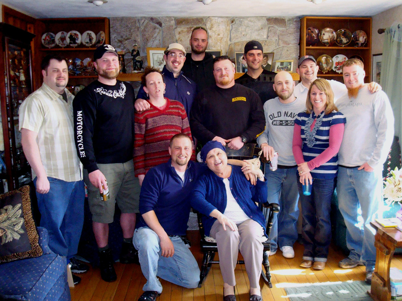 Gayle Marie Page, seated, poses with her son Troy Haskell and former house guests at her residence in Buxton. Mrs. Page was remembered for inviting children who needed a place to stay into her home.