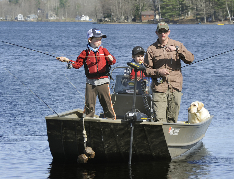 Jax casts while dad Kevin, brother Tait and dog Feta look on.