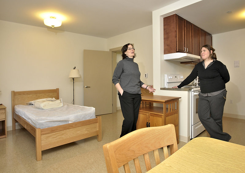 Debora Keller, left, director of development for Avesta Housing, and Amanda Wells, coordinator for Florence House, give a tour of the new home for homeless women on Valley Street last week. This is one of the independent living rooms at the facility.