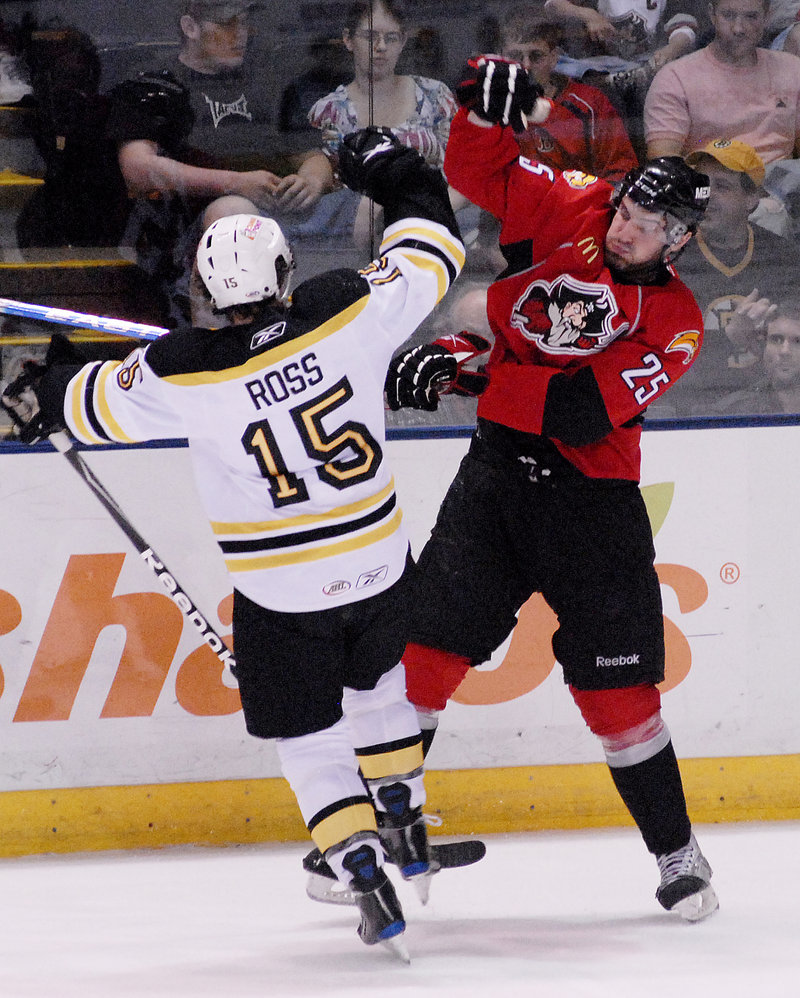 Mark Mancari, right, of the Pirates checks Providence's Jared Ross. Portland missed a chance to move into a first-place tie in the Atlantic Division, losing 3-2 in overtime.