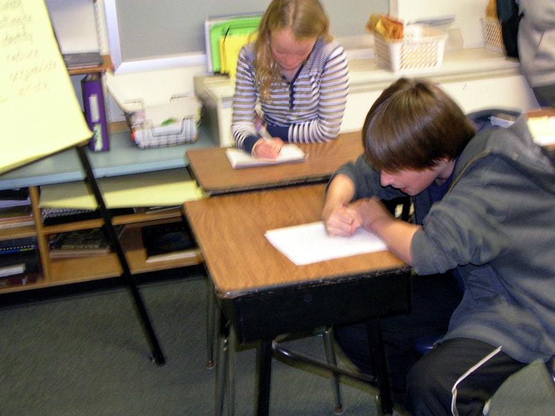 North Yarmouth Memorial School fifth-grader Maxwell Burns writes to author Rick Riordan, while his classmate writes to actor Mike Myers.The students are hoping celebrities will respond to their requests for money to ship books to the Chikumbuso Project in Lusaka, Zambia.