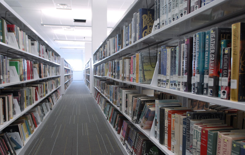 Books sit on shelves at the Portland Public Library awaiting patrons. Cutbacks at branches are justified if they help the main library do a better job, readers say.