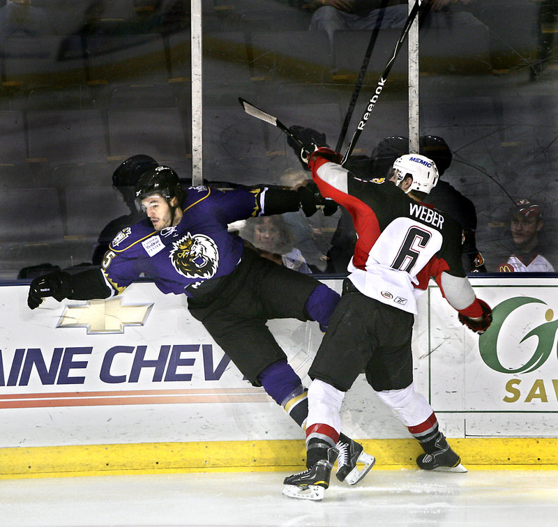 Pirates defenseman Mike Weber checks Kevin Westgarth of the Manchester Monarchs during Game 1 of their AHL playoff series Friday night at the Cumberland County Civic Center. Manchester rallied for a 2-1 win.