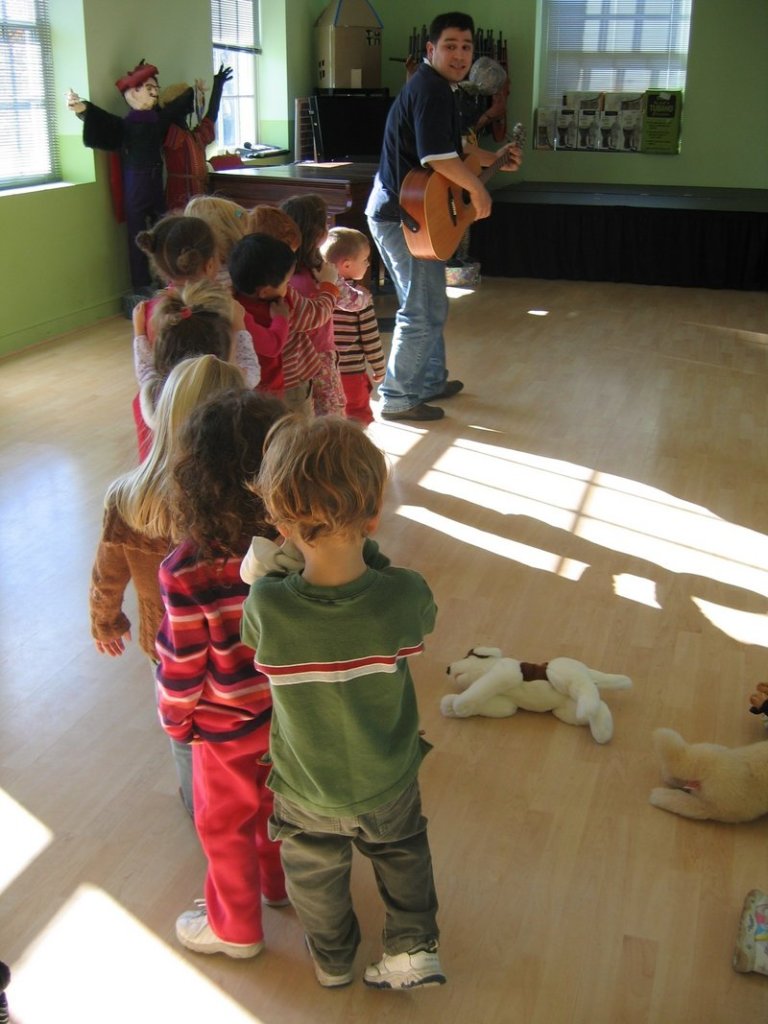 Youngsters are led in a singalong at Fiddlehead Art and Science Center in Gray. An auction to support the center will be held May 1.