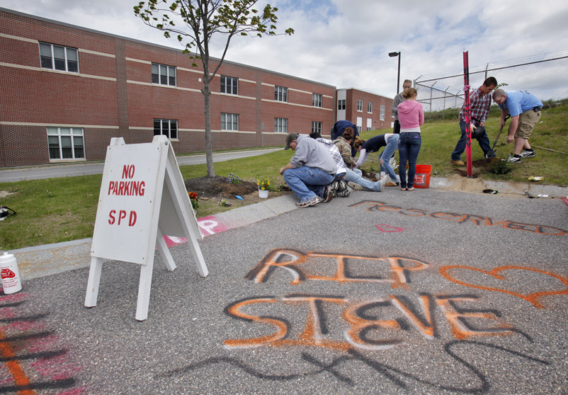 Scarborough High School students plant flowers on today around the parking spot at the school where senior Steven Delano always parked his Chevy truck.