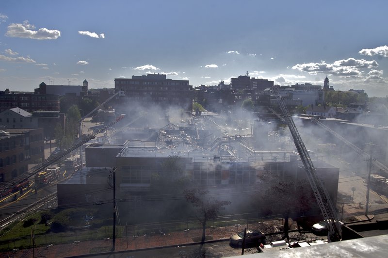 The view from the parking garage at India and Fore streets, where Portland firefighters established an observation post, shows smoke hanging over the former Jordan’s Meats plant Thursday. Once fire crews were told there was no one in the building, they focused on making sure the fire didn’t spread to surrounding businesses, Fire Chief Fred LaMontagne said.