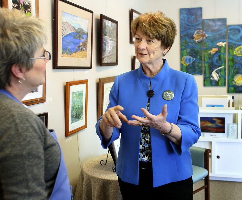 Libby Mitchell visits with artist Susan Mesick on Tuesday at a gallery in downtown Sanford while campaigning for governor.