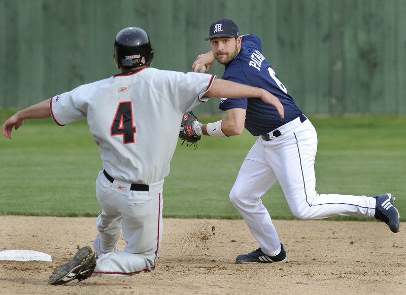 John Patriquin/Staff Photographer University of Maine shortstop Tony Patane avoids Northeasterns Frank Compagnone and throws to first base to complete a double play during a baseball game Tuesday at Goodall Park in Sanford. Maine overcame a 2-1 deficit and pulled away for an 8-3 victory.