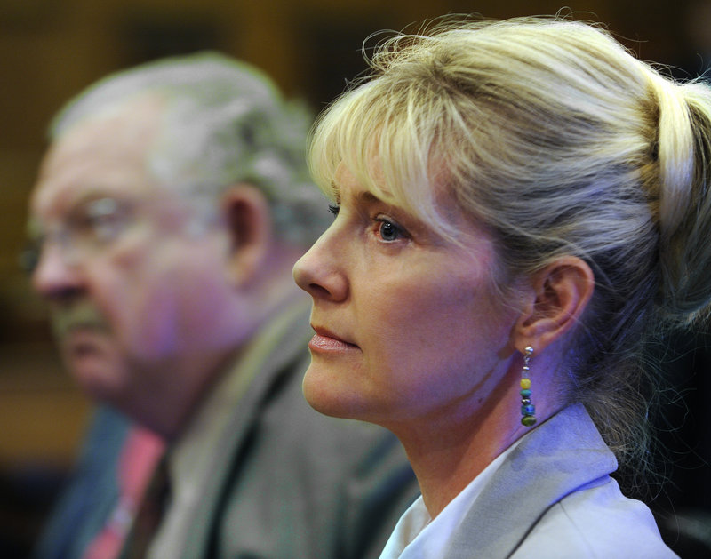 Accompanied by defense attorney Daniel G. Lilley, Linda Dolloff listens as the jury that convicted her is polled last month. She was found guilty of attempting to murder her husband, Jeffrey Dolloff, with a softball bat.