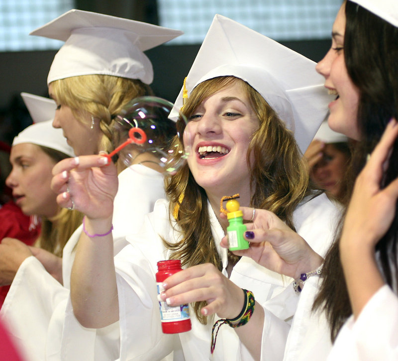 Senior Ashley Virgilio catches a bubble during the graduation.