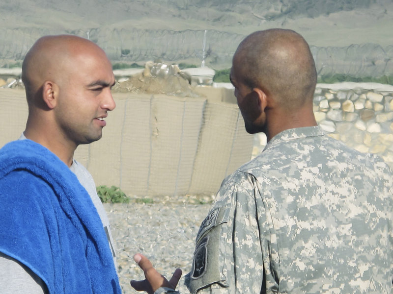 Pfc. Hamayon Ahadi of Biddeford, who was born in Kabul and moved to the United States at age 2, chats with a Bravo Company interpreter Monday at Combat Outpost Dand wa Patan.