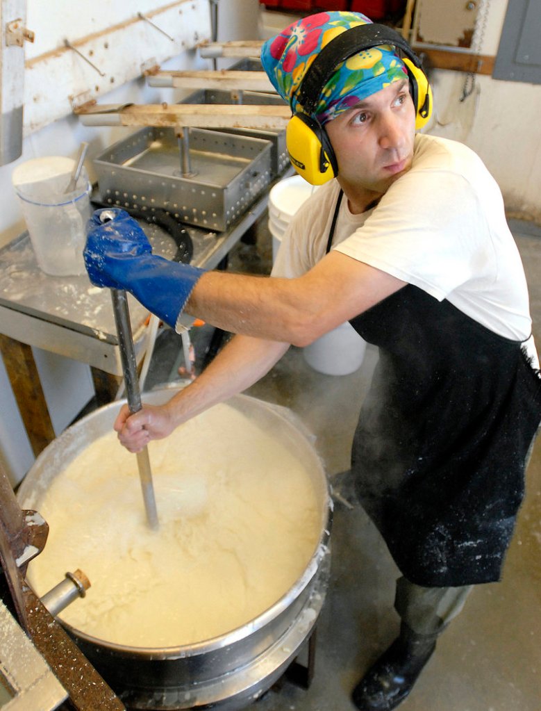 Jeff Wolovitz stirs calcium sulfate into soymilk to make curds and whey. Wolovitz and his wife, Maho Hisakawa, operate a small tofu company, Heiwa Tofu, out of a garage in Camden.