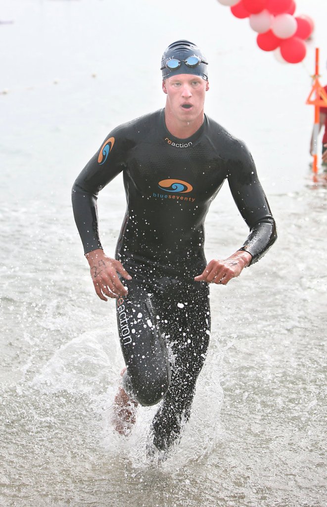 Nick Daly of Cape Elizabeth jogs onto East End Beach to complete the 29th Peaks to Portland swim. Daly was the overall winner for the second straight year.