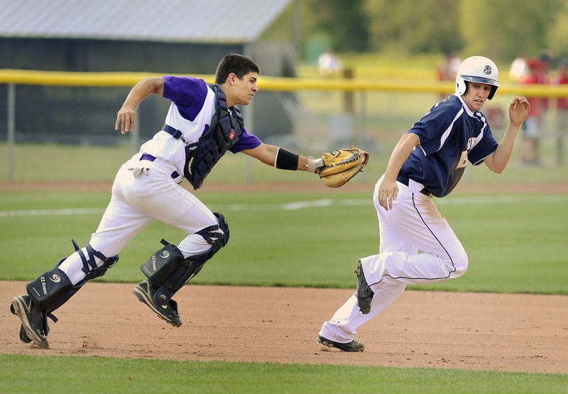 John Miranda of Nova Seafood runs down Nathan Lewis of Bangor between second and third base in the third inning.