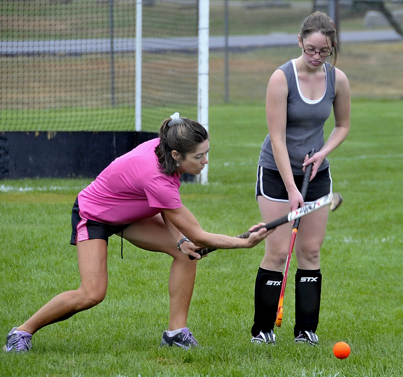 Leslie Mourmouras, Biddeford's new field hockey coach, gives instructions to Josie Rhoy.