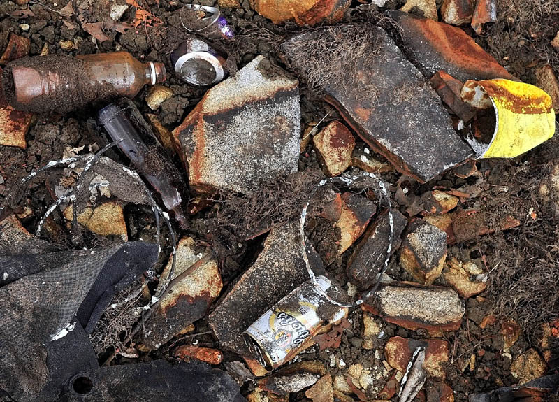 Cans, bottles and other trash cover the floor of the recently-drained Stinchfield Quarry in Hallowell.