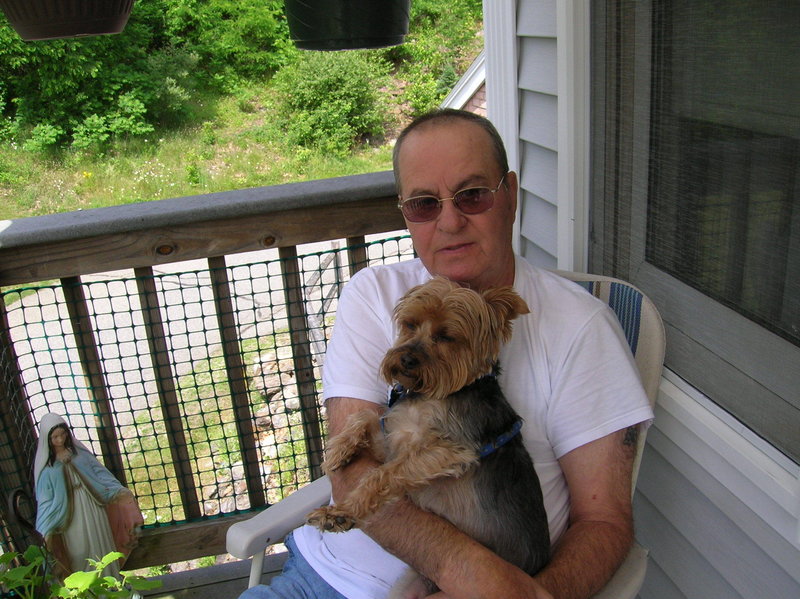 John Pizzo holds Buddy, a Yorkshire terrier that he bought for his wife five years ago. He took the dog for walks every morning. “He really loved that dog,” his daughter said.