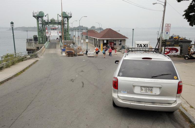 A taxi with Island Transportation System on Peaks Island waits for customers near the island's dock on Thursday. The company says it is losing business to Matt Rand, a summer resident who offers free rides in his golf cart and makes money from tips.