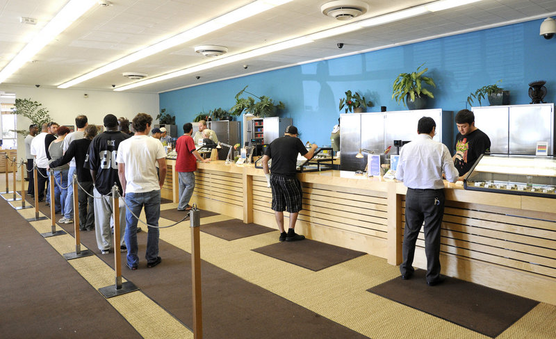 Patients wait in line for their medication at the Harborside Health Center in Oakland, Calif. Harborside serves up to 800 patients each day, did about $20 million in sales last year and employs 80 people with a starting wage of $14 per hour.