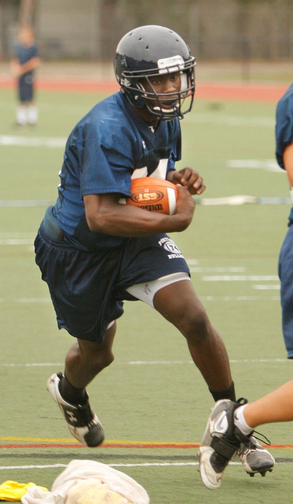 Portland running back Imadhi Zagon runs a play during his team's practice at Fitzpatrick Stadium. Zagon was an All-State selection last year, when he rushed for 1,375 yards and scored 17 touchdowns. The Bulldogs will face Deering in their season opener Sept. 3 at Fitzpatrick Stadium.