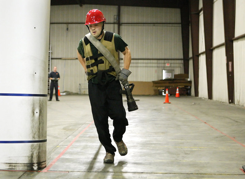 Robert Newberry, 31, a call firefighter in Raymond who aspires to become a full-time firefighter, participates in the Candidate Physical Ability Test at a warehouse on Read Street in Portland on Wednesday.