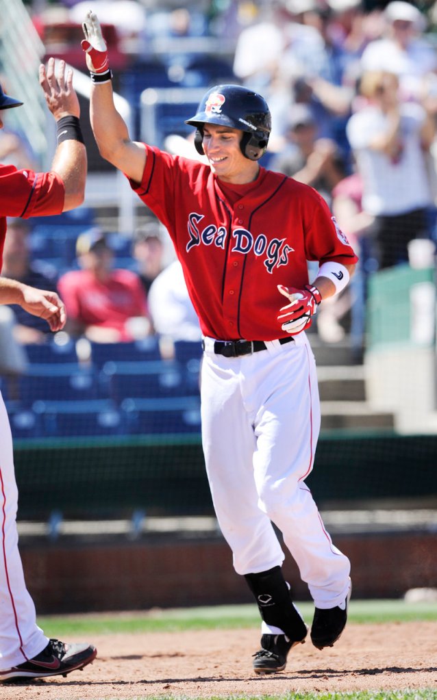 Nate Spears gets congratulations at home plate after hitting a two-run homer in the fourth inning, one of five home runs by the Sea Dogs in a 9-8 victory over Altoona on Thursday.