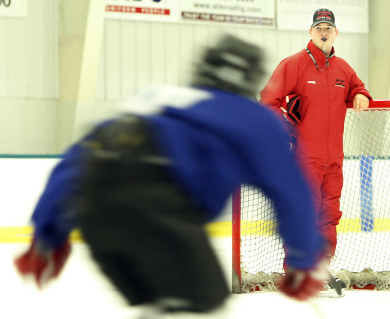 Skating coach Adam Nicholas surveys a group at a recent power skating practice. Nicholas, 25, is the new boys’ hockey coach at Falmouth.