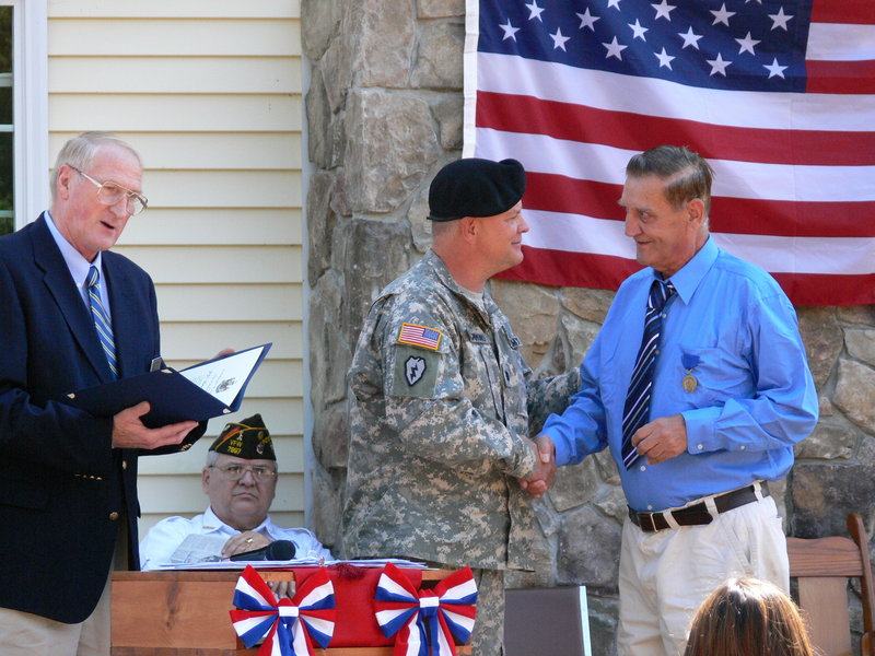 Herbert "Junior" Joy, right, is awarded a Maine service medal for his heroic deeds in the Korean War. More than 1,000 Maine veterans have been re-recognized since a state program began in 2006. Presenting the award are, from left, Peter Ogden, Maine Bureau of Veteran Services director; VFW Post 7997 Cmdr. Richard P. Giroux and Army Lt. Col. Dwayne Drummond.