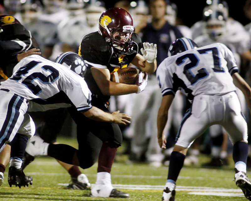 Jack Barber of Cape Elizabeth is pursued by York's Alex Jannetti, left, and Thomas Kinton during the Capers 21-0 victory Friday night.