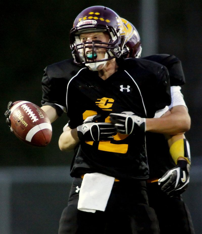 Derek Roberts of Cape Elizabeth celebrates after intercepting a pass in the first quarter, setting up the game's first touchdown.