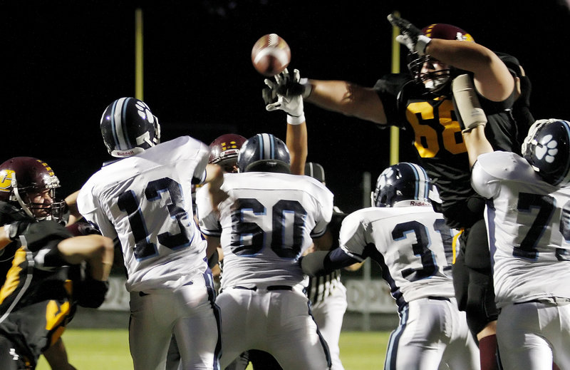 Andrew Lavallee reaches over York's line to knock down a pass by Wesley Warner, left. Cape Elizabeth allowed just one first down in the first half on the way to its second straight shutout.