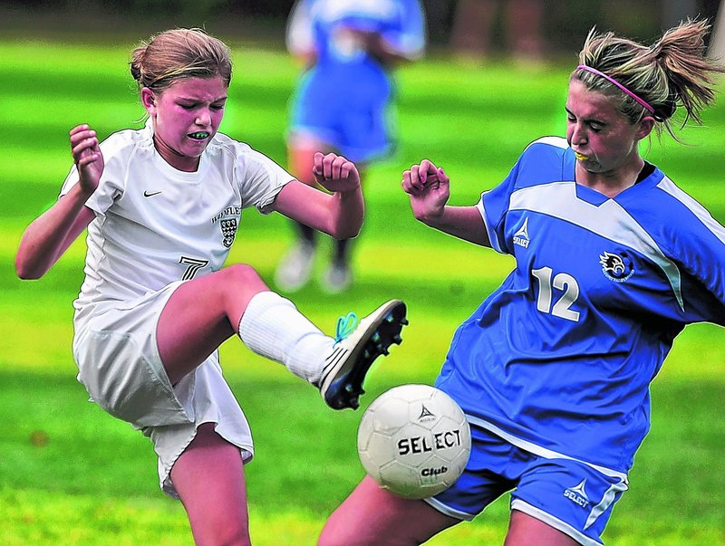 Walker Foehl, left, of Waynflete tries to kick the ball away from Amanda Cressy of Sacopee Valley during Sacopee’s overtime win.