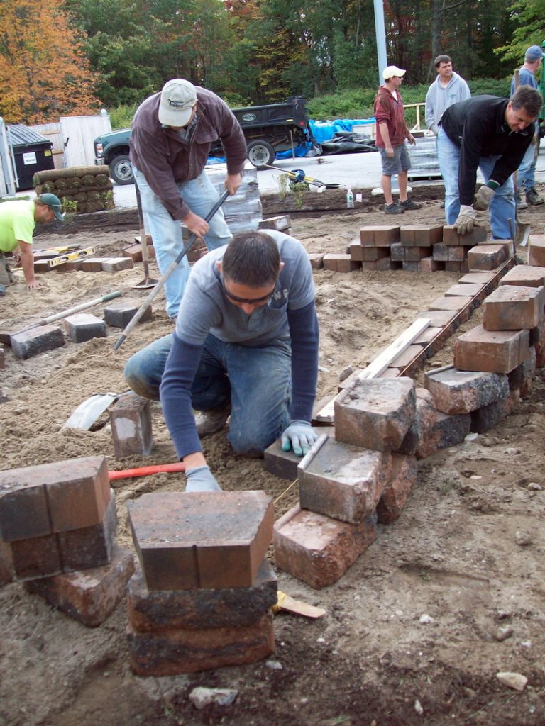 Luis Juarez of Sabra Property Care in Cumberland works on the raised beds.