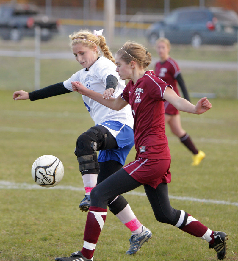 Amy Twohig, left, of Old Orchard Beach and Katelyn McAuliffe of Richmond battle for possession. Despite its loss, Richmond will be the No. 1 seed in Western Class D.