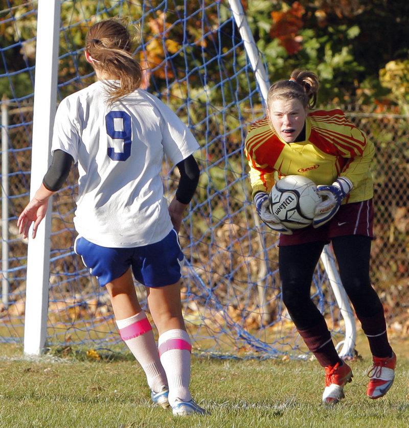 Lindsy Hoopingarner of Richmond scoops up the ball in front of Olivia Dubois of Old Orchard Beach during Monday’s game at Old Orchard Beach. Richmond suffered its first loss, 3-0.