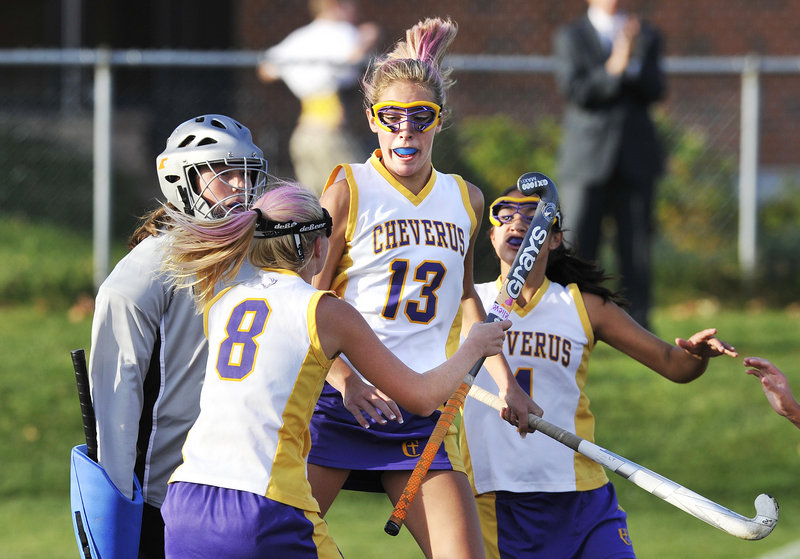 John Ewing/Staff Photographer Brooke Flaherty of Cheverus, 13, celebrates with Anna McDonough, 8, and Gabi Cardona after scoring late in the first half to tie it and swing the momentum against Kennebunk.